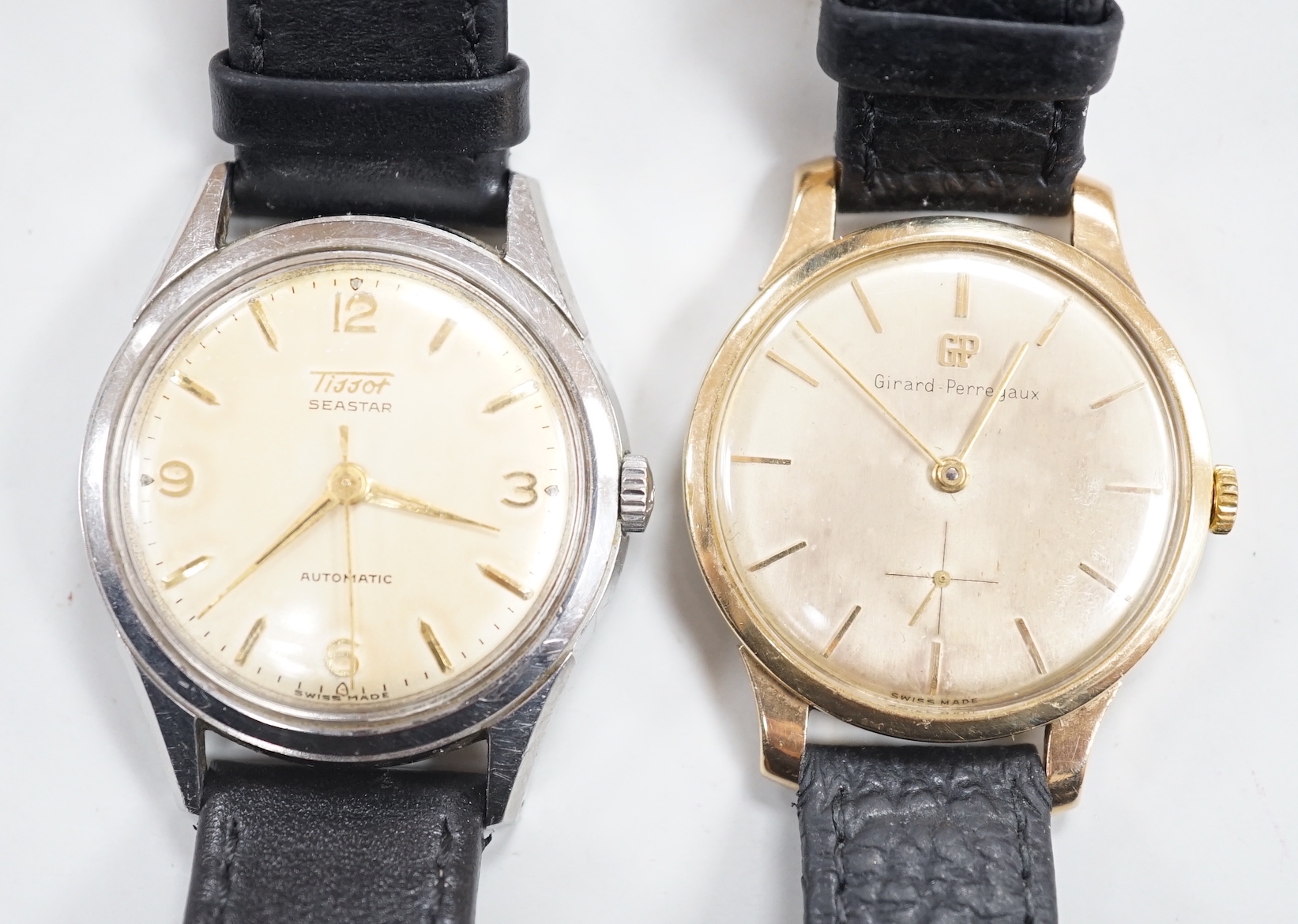 A gentleman's 9ct gold Girard Perregaux manual wind wrist watch, on associated leather strap and a gentleman's stainless steel Tissot Seastar automatic wrist watch.